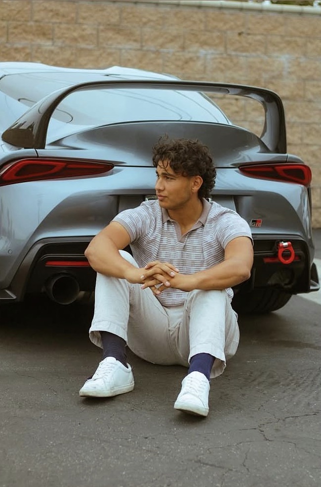 Ashton Salah beside a Toyota Supra